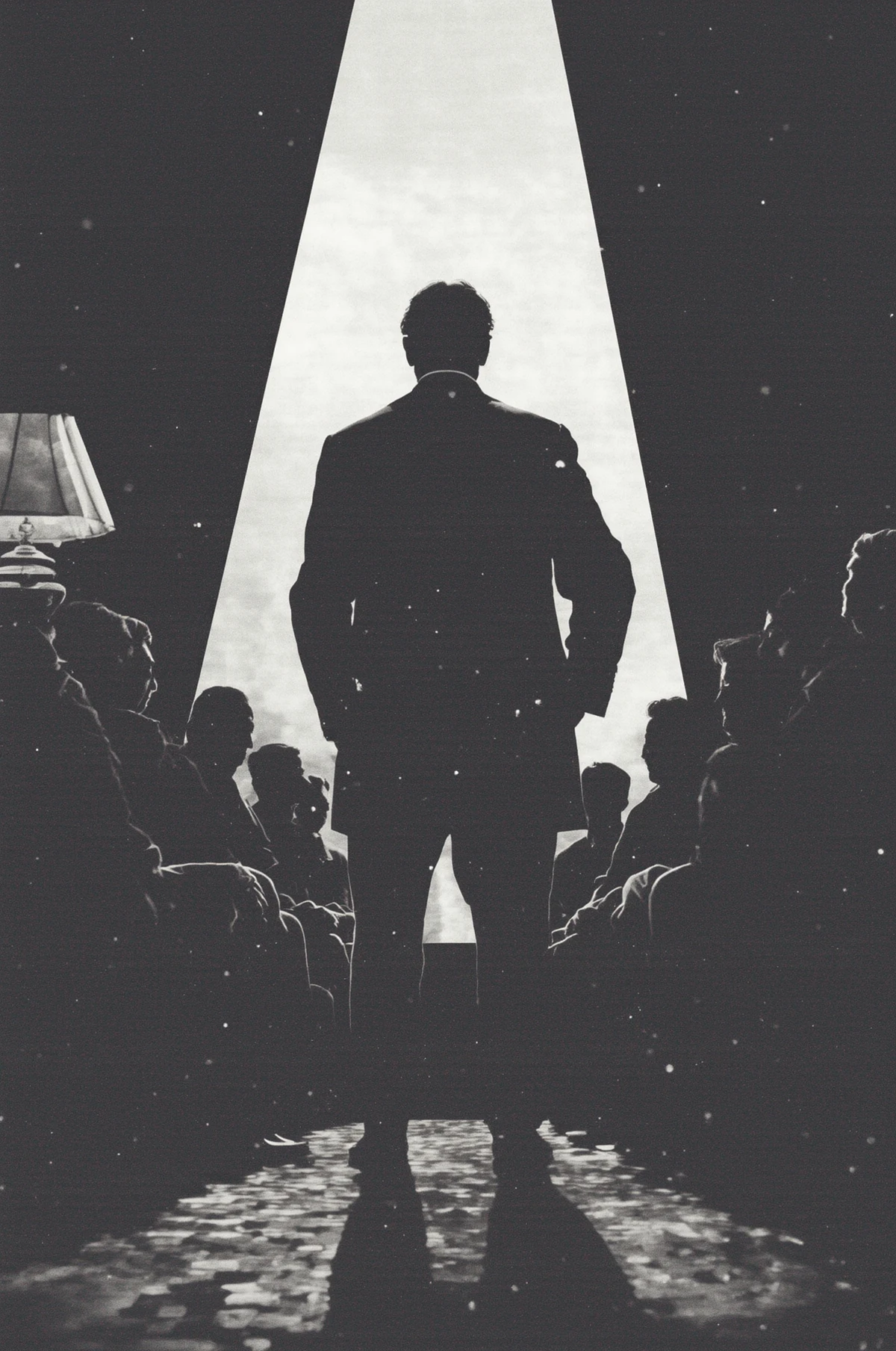 A lone figure stands before an audience beneath a harsh beam of light.